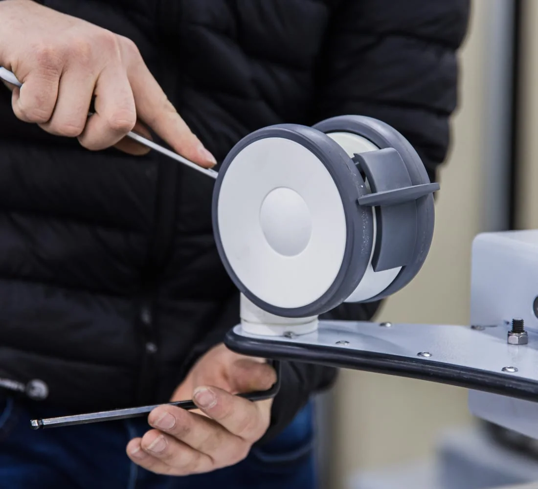 Blue White Medical technician fitting precision hardware to a positioning device