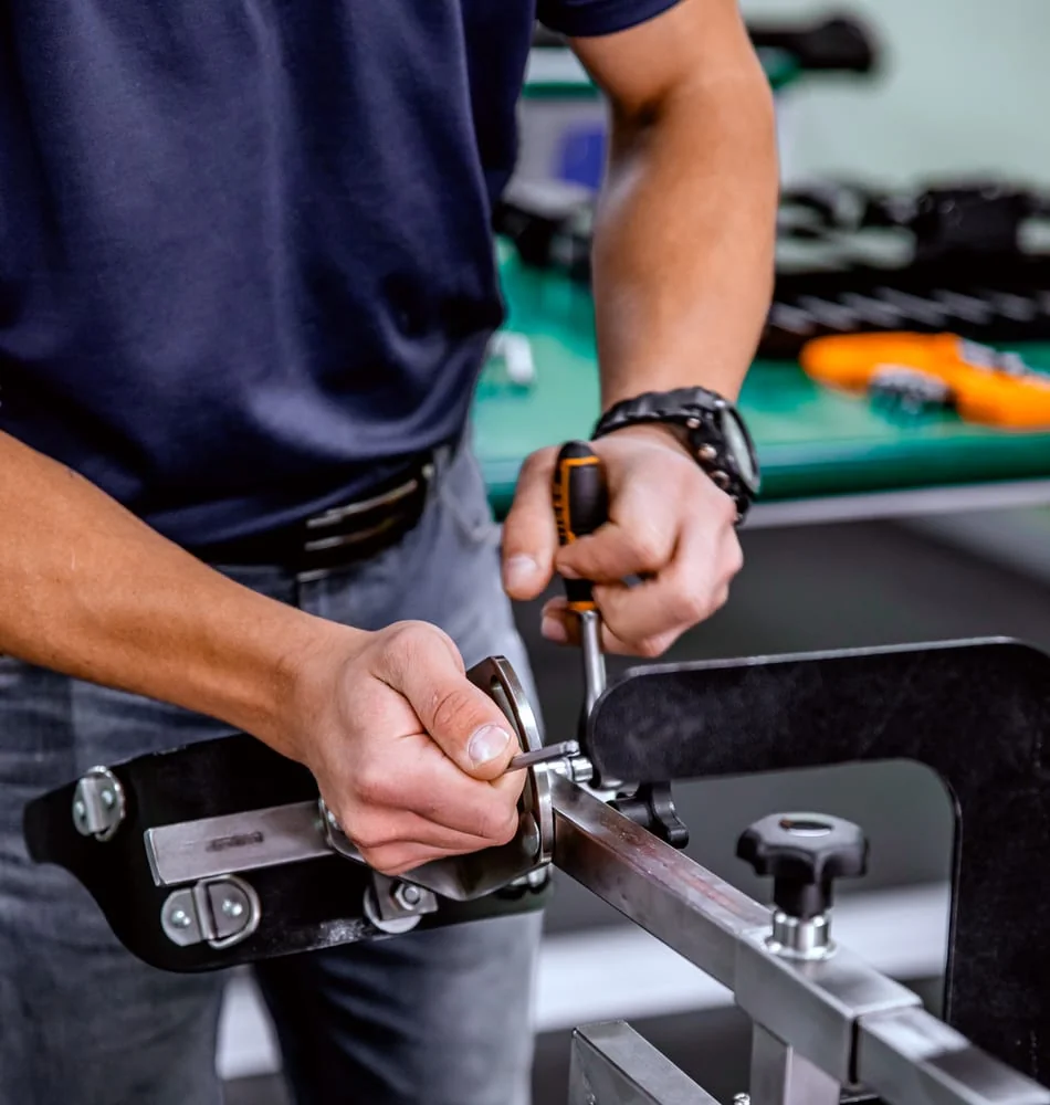 Blue White Medical technician fitting a precision mechanism in the Pretoria workshop