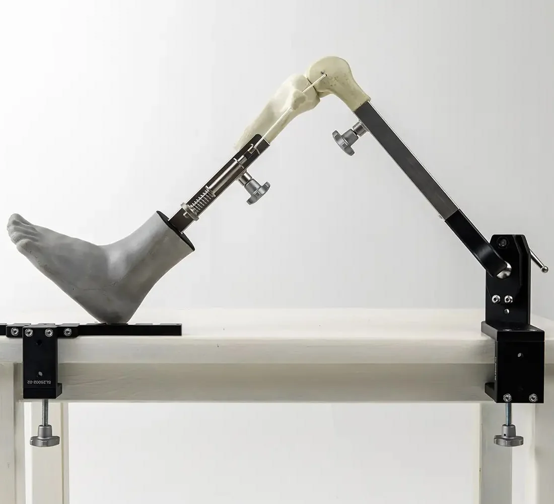 Shane's Leg, a Blue White Medical arthroplasty training product, clamped to a table